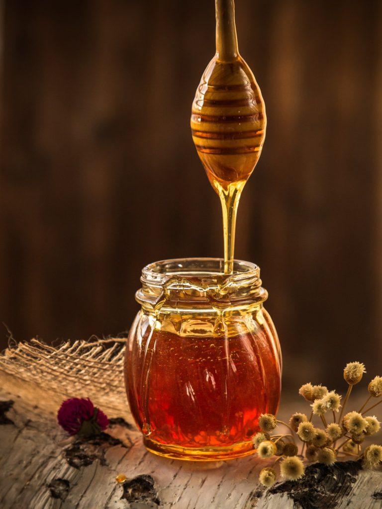 An open jar of honey.