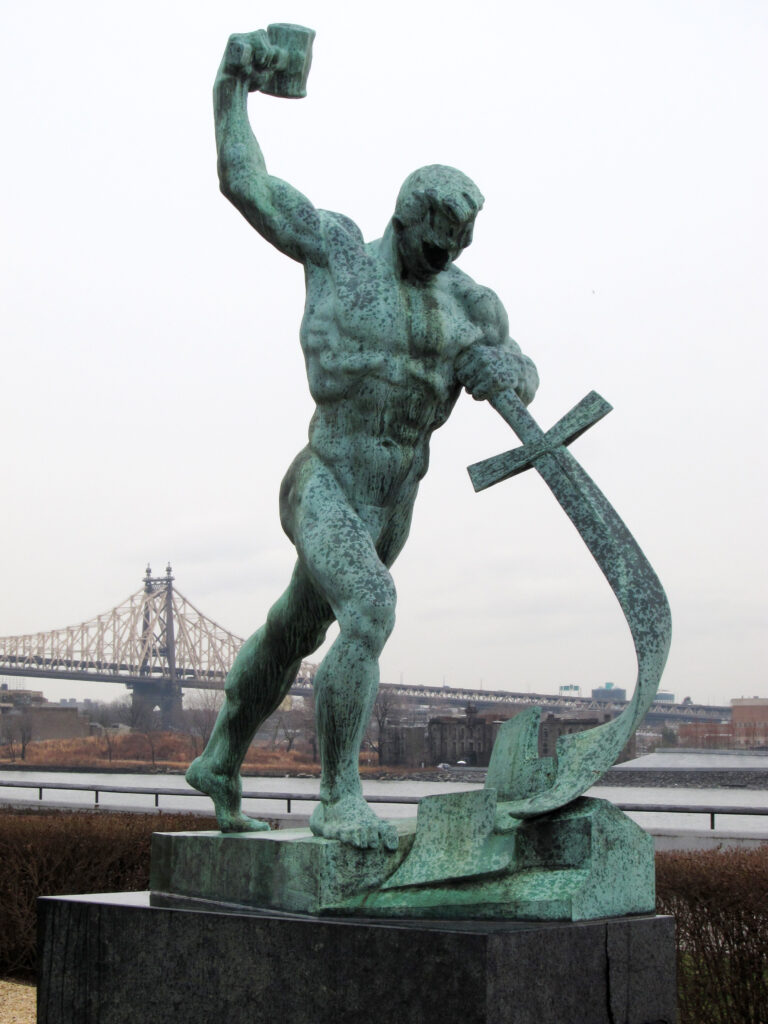 A photograph of a sculpture depicting a sword being beaten into a ploughshare